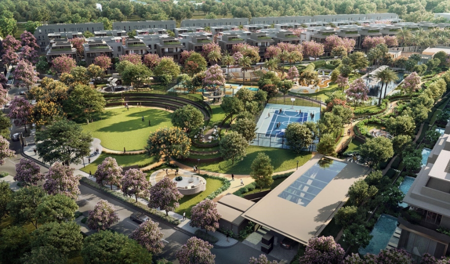 Từ trên cao nhìn xuống, công viên trung tâm như một tấm thảm xanh trải dài, đan xen những mảng màu rực rỡ của hoa lá, dẫn lối từng góc vui chơi và thư giãn. Ảnh: CapitaLand.