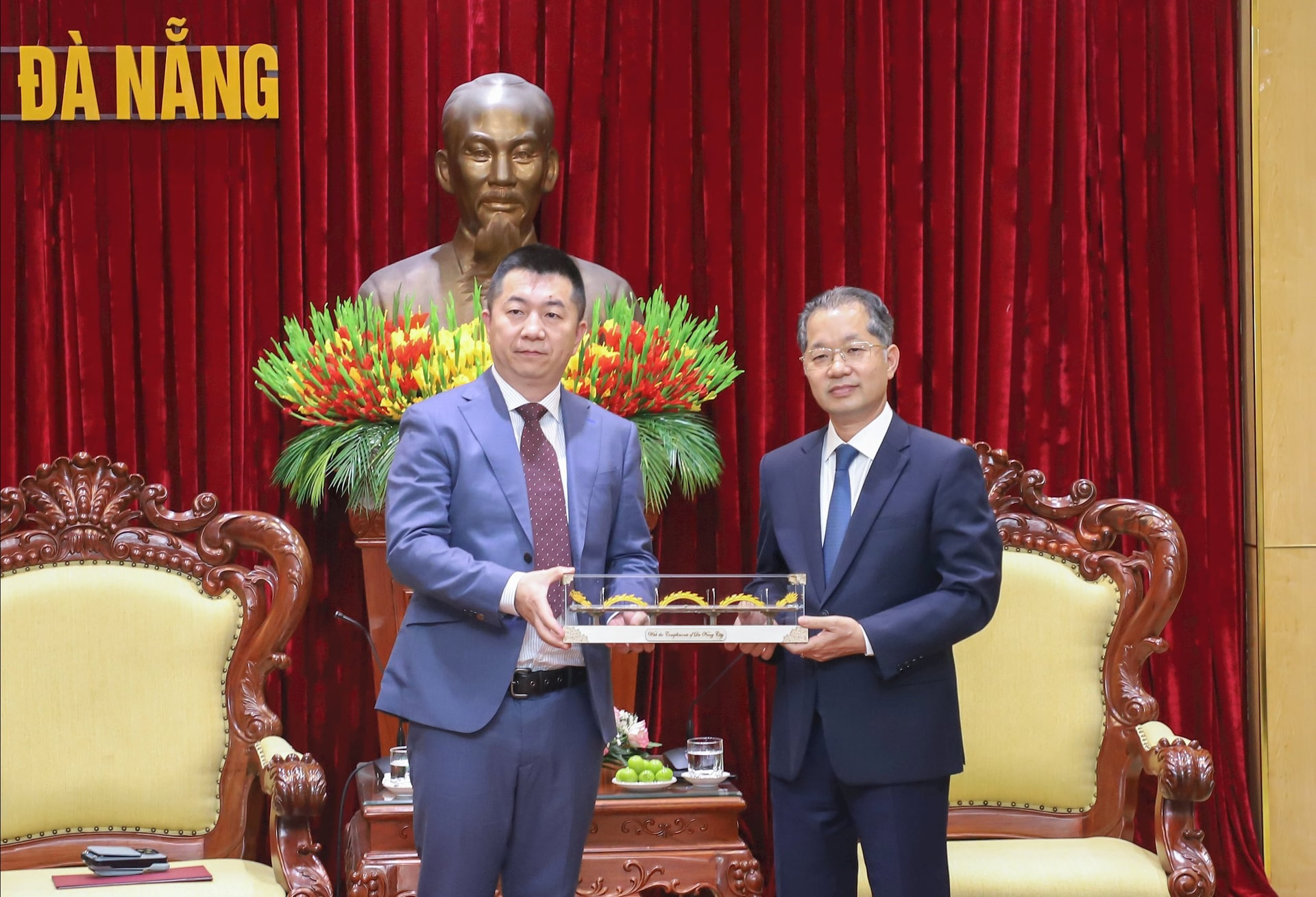 Bí thư Thành ủy Nguyễn Văn Quảng (bên phải) tặng quà lưu niệm cho ông Band Zhao. Ảnh: NGỌC PHÚ.