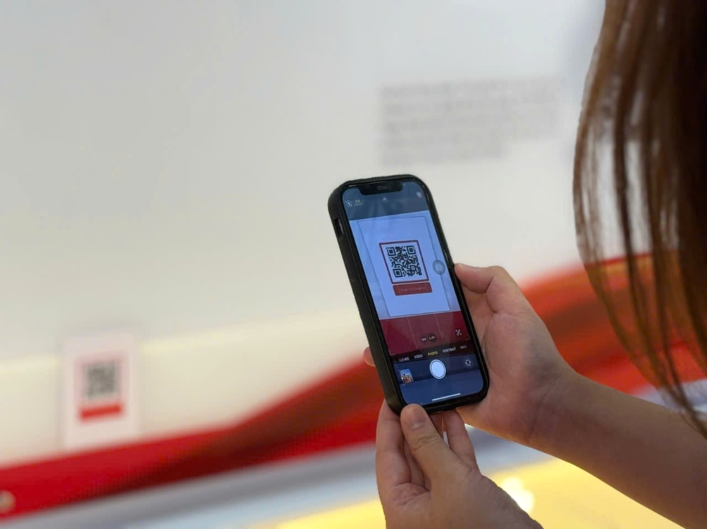 Each photo panel includes a QR code providing details in both Vietnamese and English for international visitors.
