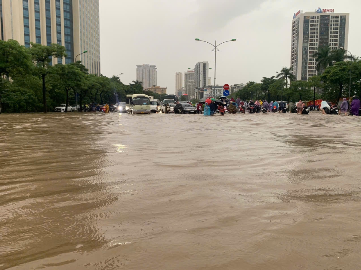 Nước ngập mênh mang tại khu vực gần sân vận động Mỹ Đình khiến khu vực này giao thông ùn tắc nghiêm trọng, người dân đi xe máy phải tắt máy dắt xe qua. Những chiếc xe ô tô gầm thấp cố tình lao qua điểm ngập này hầu hết đều chết máy phải gọi cứu hộ...&nbsp;