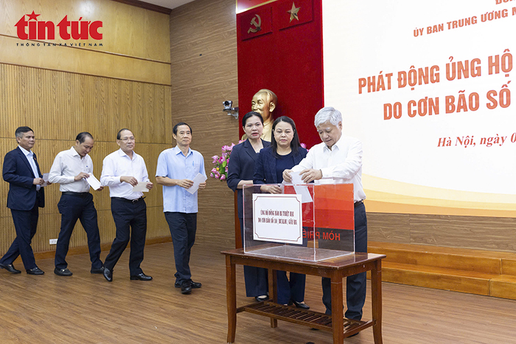 Chủ tịch Ủy ban Trung ương Mặt trận Tổ quốc Việt Nam Đỗ Văn Chiến và các đại biểu ủng hộ đồng bào chịu ảnh hưởng bởi cơn bão số 10. Ảnh: TTXVN.