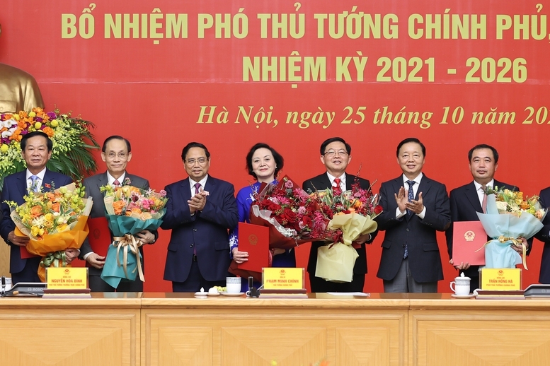 Thủ tướng trao quyết định và tặng hoa cho các Phó Thủ tướng và Bộ trưởng - Ảnh: VGP.