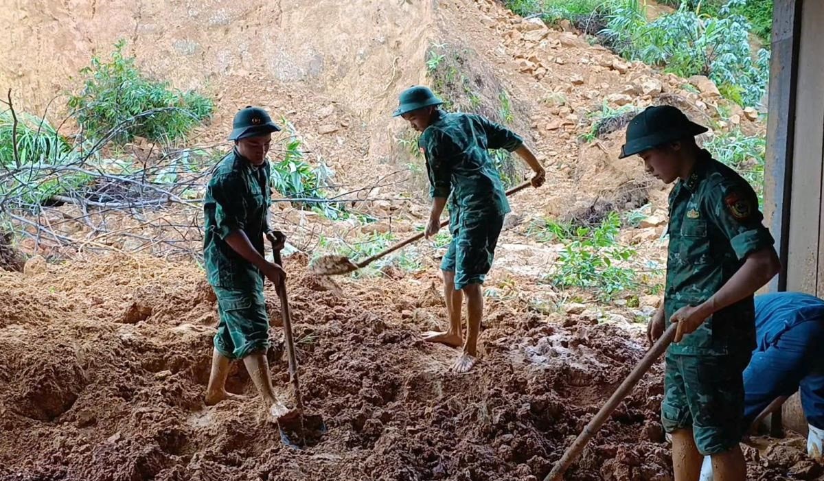 Cán bộ Đồn Biên phòng cửa khẩu A Đớt và các lực lượng thu dọn khối lượng đất sạt lở.