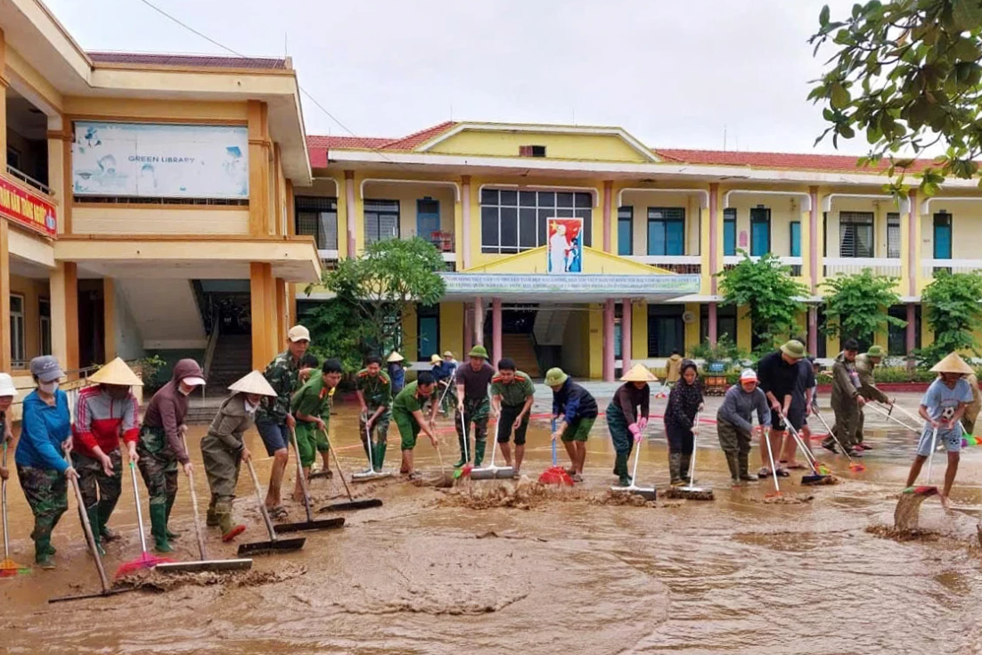 Sau lũ rút, người dân miền Trung khẩn trương thu dọn bùn đất, rác thải