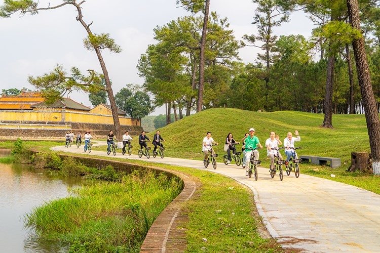 Du khách trải nghiệm xe đạp tham quan tour du lịch xanh tại di tích lăng vua Gia Long.