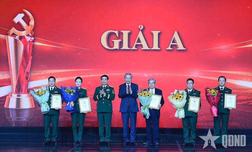 Tổng Bí thư Tô Lâm, Bí thư Quân ủy Trung ương và Đại tướng Phan Văn Giang, Ủy viên Bộ Chính trị, Phó bí thư Quân ủy Trung ương, Bộ trưởng Bộ Quốc phòng trao giải A tặng các tác giả, nhóm tác giả. Ảnh: QĐND.