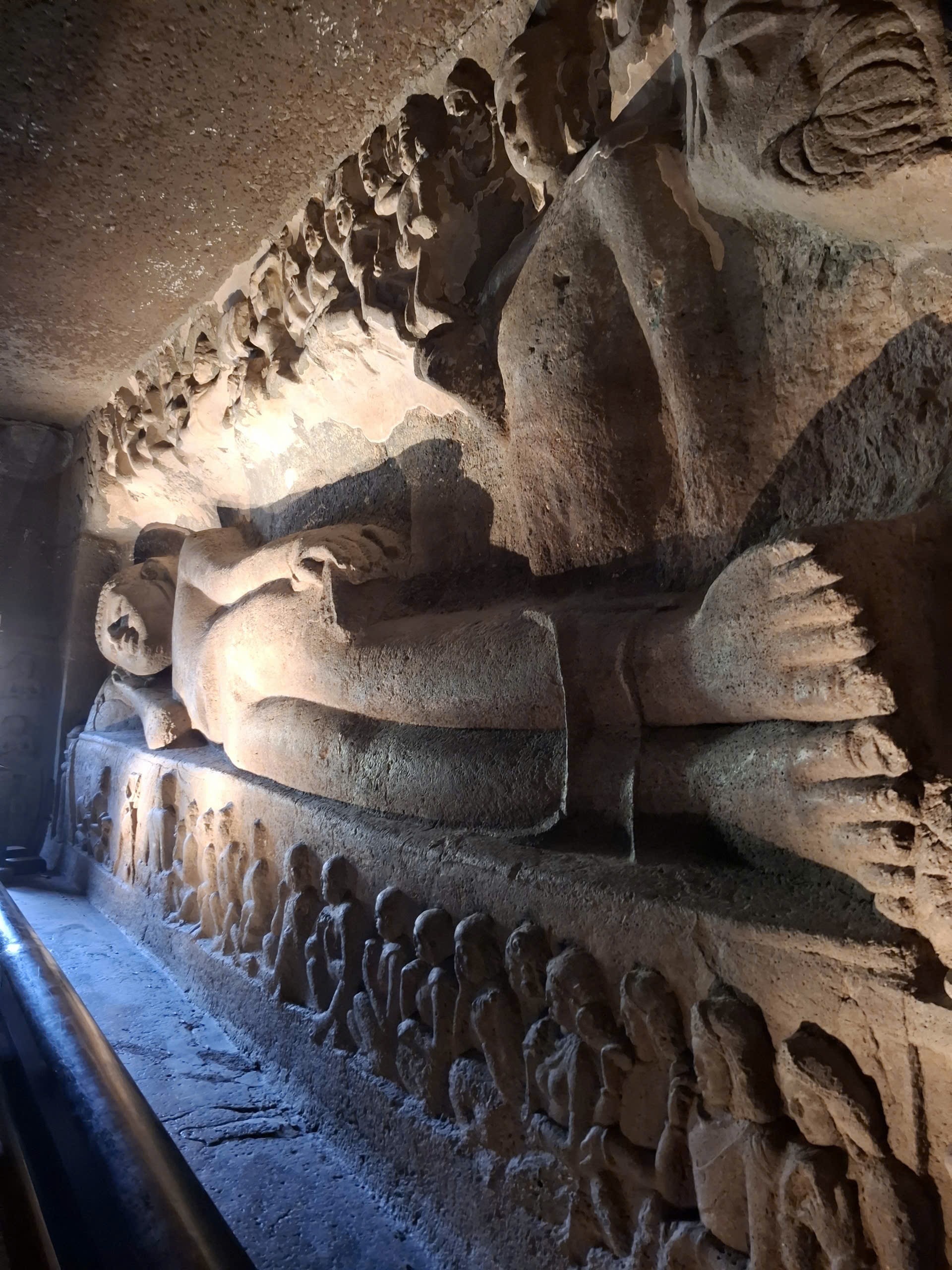 A large reclining Buddha sculpture carved into the rock inside Ajanta Caves, depicting the Buddha entering Parinirvana. Photo: Trong Thoan.