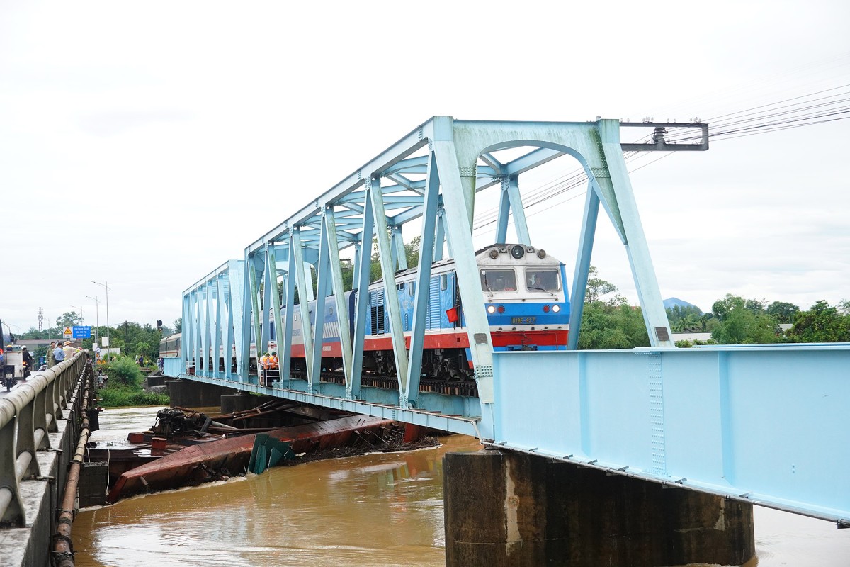 Sà lan bị nước dâng cao cuốn trôi và mắc kẹt tại cầu đường sắt Mỹ Chánh, xã Nam Hải Lăng. Ảnh: rường Nhật