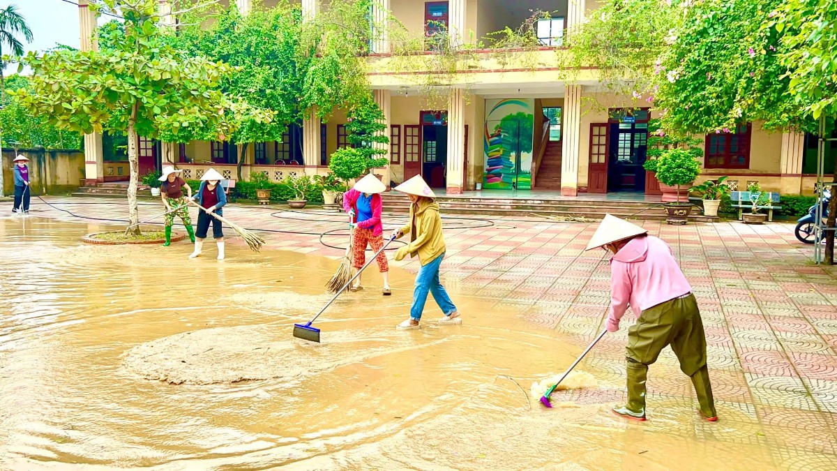 Cán bộ, giáo viên Trường THCS Nông Cống, phân hiệu Vạn Thiện khẩn trương vệ sinh trường học sau khi nước lũ rút. Ảnh: Nguyễn Thuấn