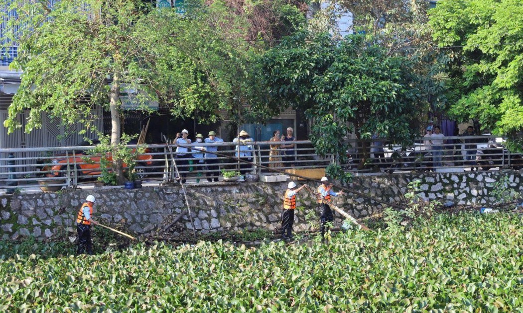 Lực lượng chức năng xử lý các điểm ách tắc dòng chảy, bảo đảm tiêu thoát nước trong khu dân cư. Ảnh: BTC